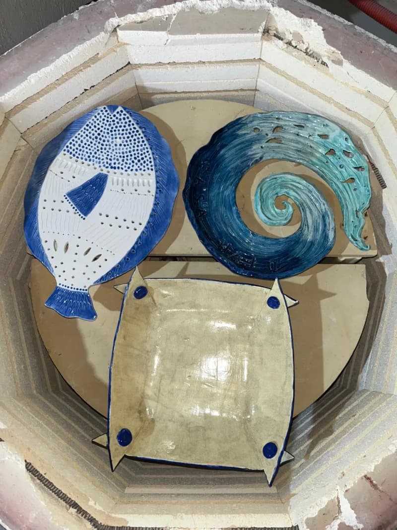 Glazed ceramic pieces in kiln after firing