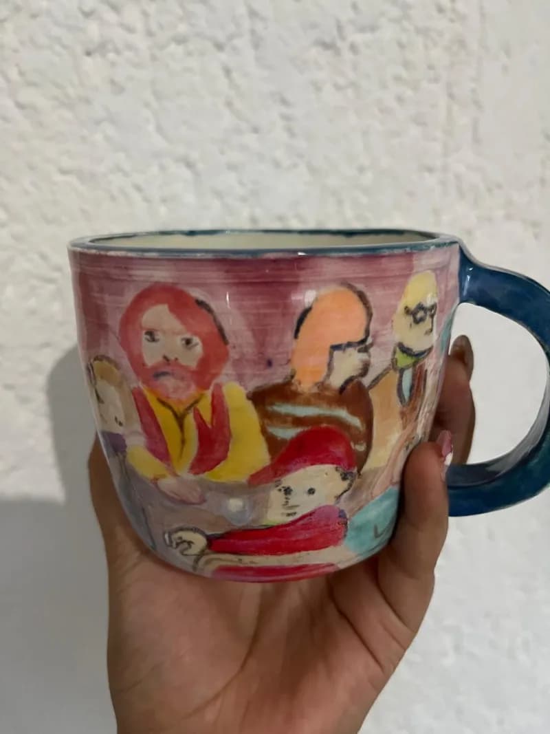 Hand-painted characters on ceramic mug